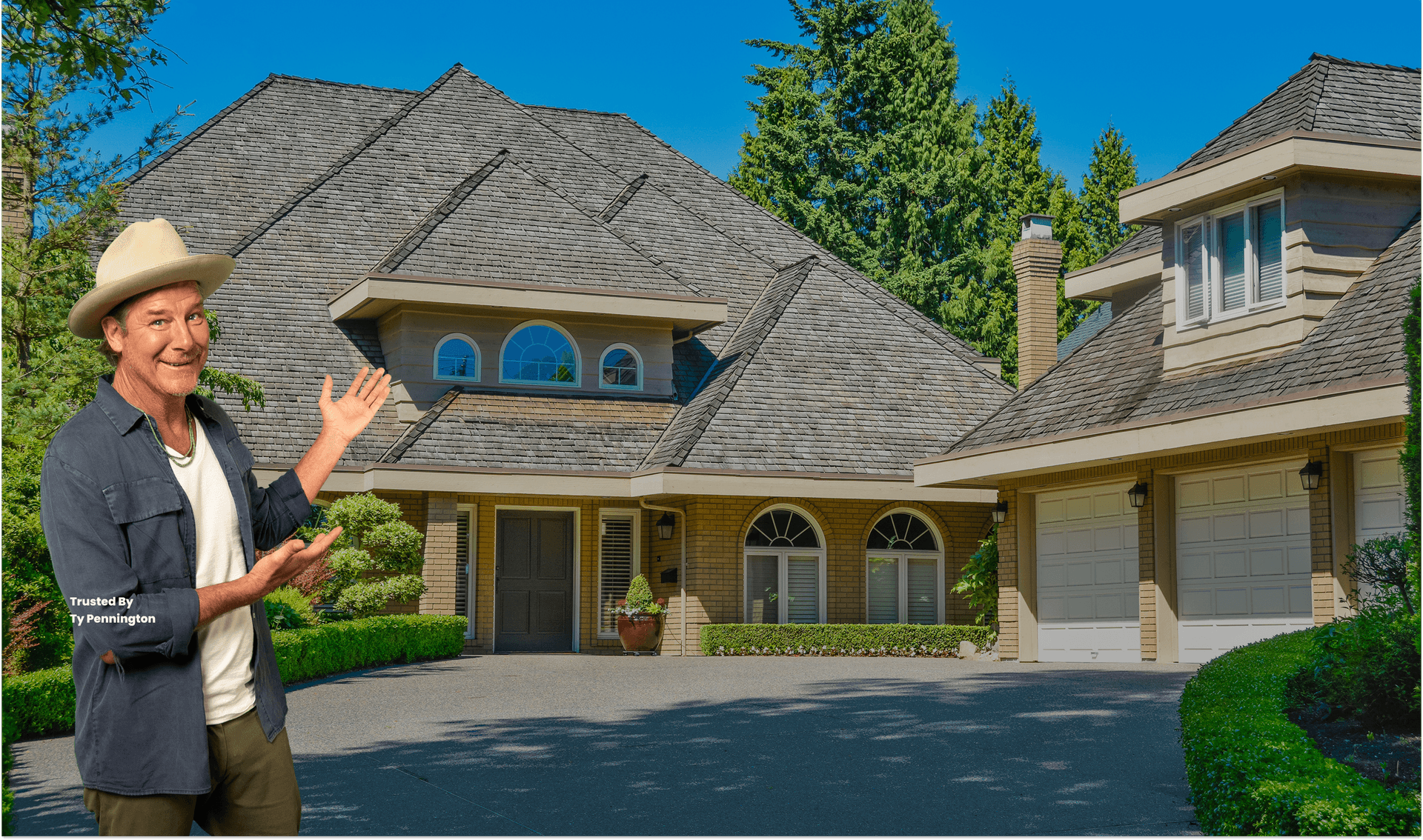 Luxurious house with a steep, intricate roof, arched windows, and a double garage. Surrounded by lush greenery, under a clear blue sky.