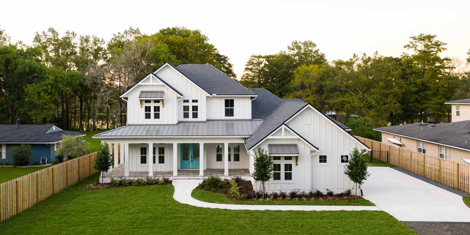 White siding home and green lawn