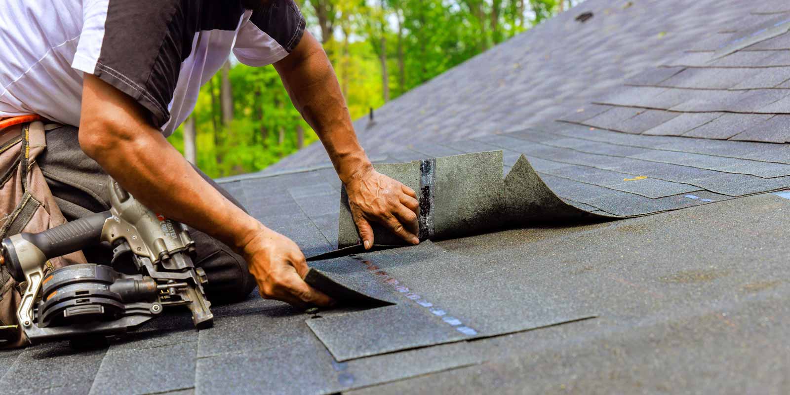 Contractor replacing shingles